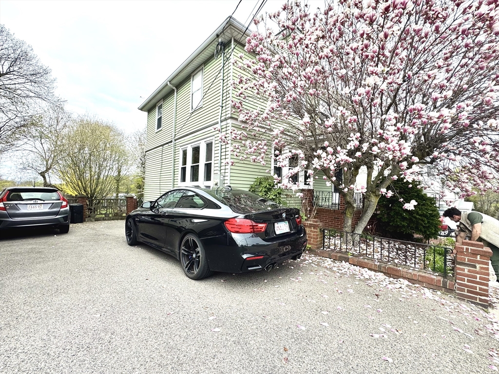 53 Breck Avenue Boston, MA 02135 - Photo 3 of 35 a car parked in front of a white house