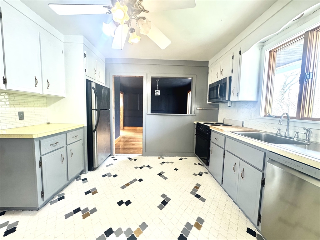 53 Breck Avenue Boston, MA 02135 - Photo 5 of 35 a kitchen with a sink stove and refrigerator
