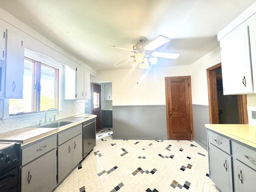 53 Breck Avenue Boston, MA 02135 - Photo 6 of 35 a kitchen with a sink stove and refrigerator