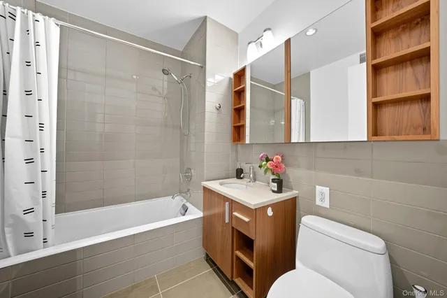 a bathroom with a sink toilet vanity and shower