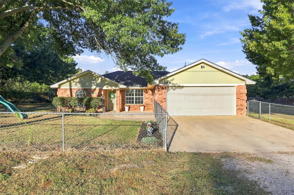 304 Sage Trail Springtown, TX 76082 - Photo 21 of 33 Front Exterior – Traditional brick home with attached two-car garage and gated front yard.