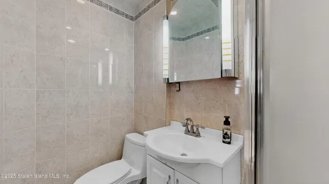 a bathroom with a sink toilet and mirror