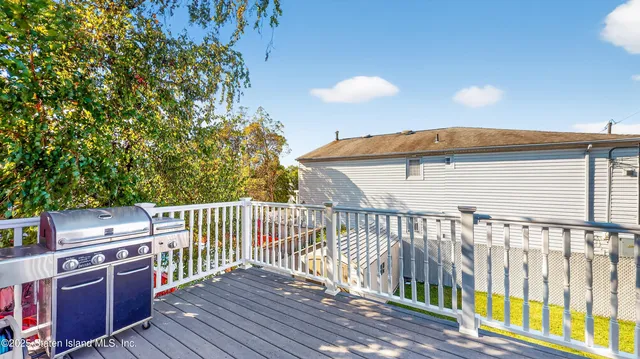 a balcony with wooden floor and fence