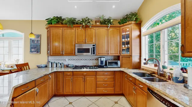 a bathroom with a granite countertop sink and a large mirror