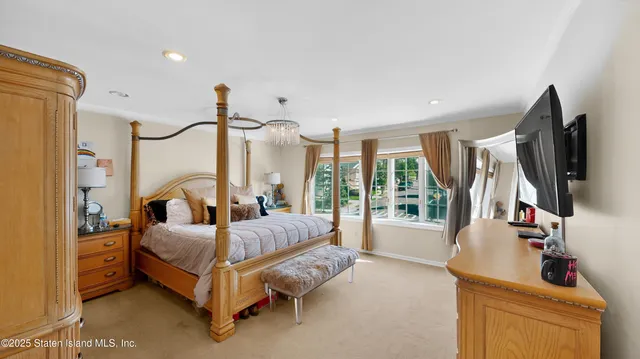 a bedroom with furniture and a flat screen tv