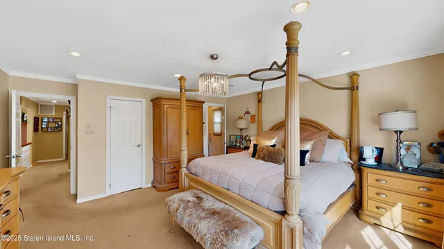 a bedroom with a bed a table and painting on the wall