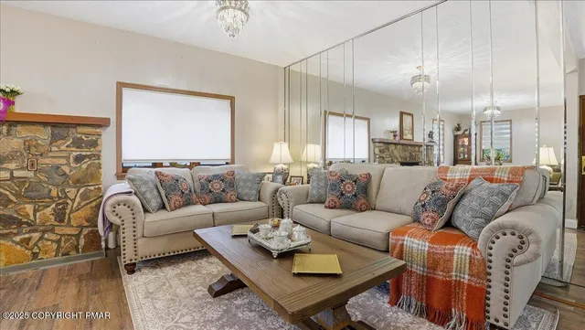 a living room with furniture a rug and a lamp