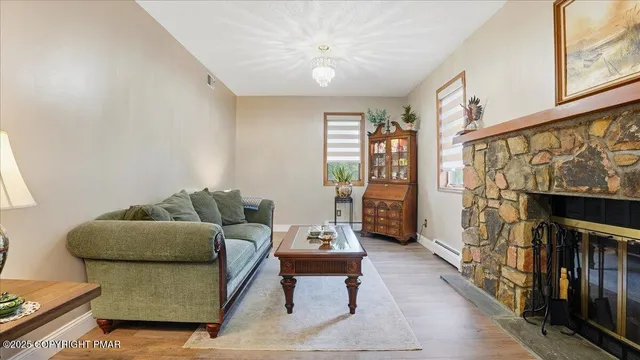 a living room with furniture and wooden floor
