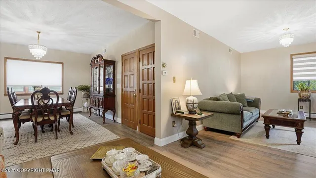 a view of a a dining room with furniture window and wooden floor