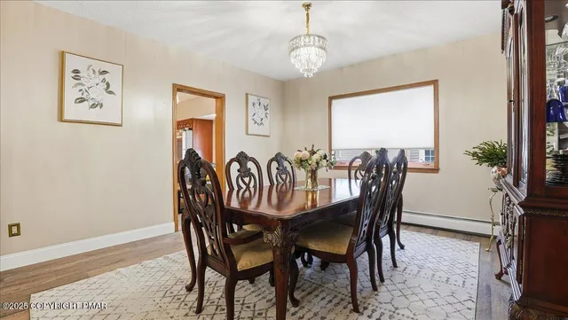 a view of a dining room with furniture and a chandelier