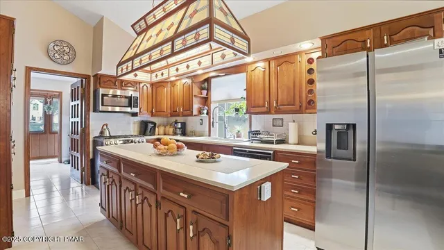 a kitchen that has a kitchen island wooden floor and stainless steel appliances