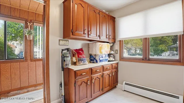 a kitchen with granite countertop white cabinets and stainless steel appliances