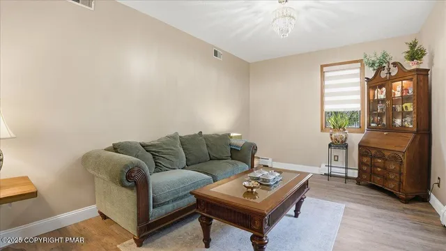 an empty room with windows and flat screen tv