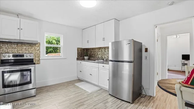 a living room with furniture flowerpot and window