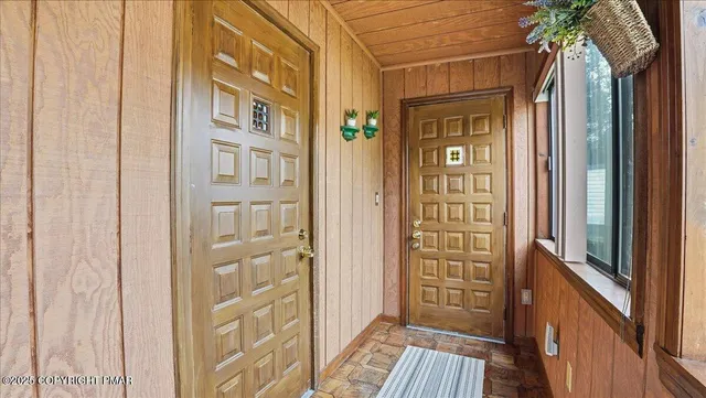 a view of a porch with two chairs and a table