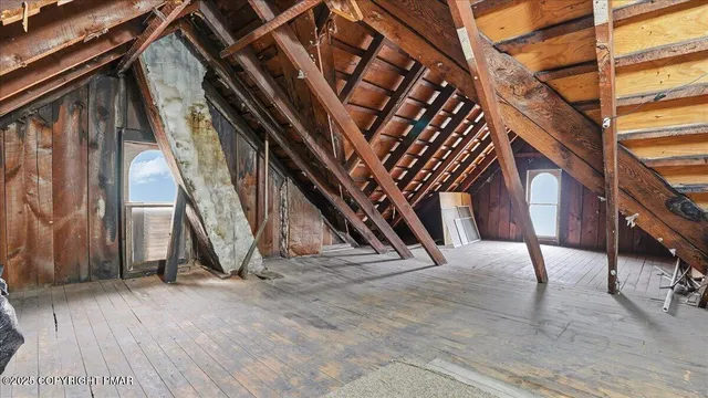 a view of a house with a small yard and wooden fence