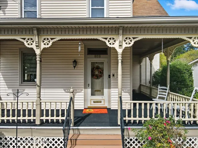 a living room with furniture and a dining table with kitchen view