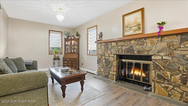 a living room with furniture and a fireplace