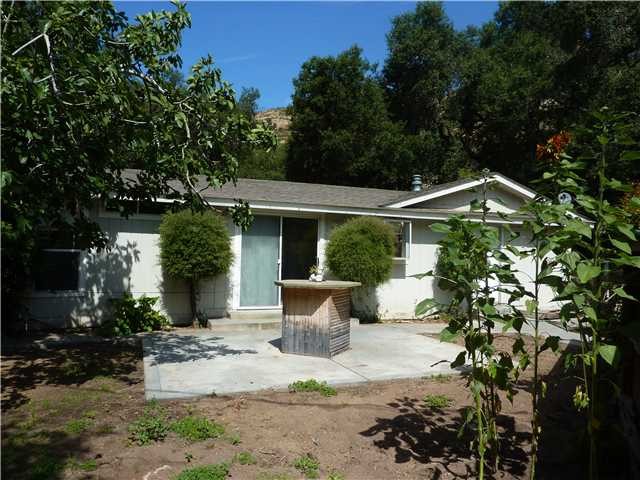 47709 Rainbow Canyon Road Temecula, CA 92592 - Photo 1 of 1 a front view of a house with garden