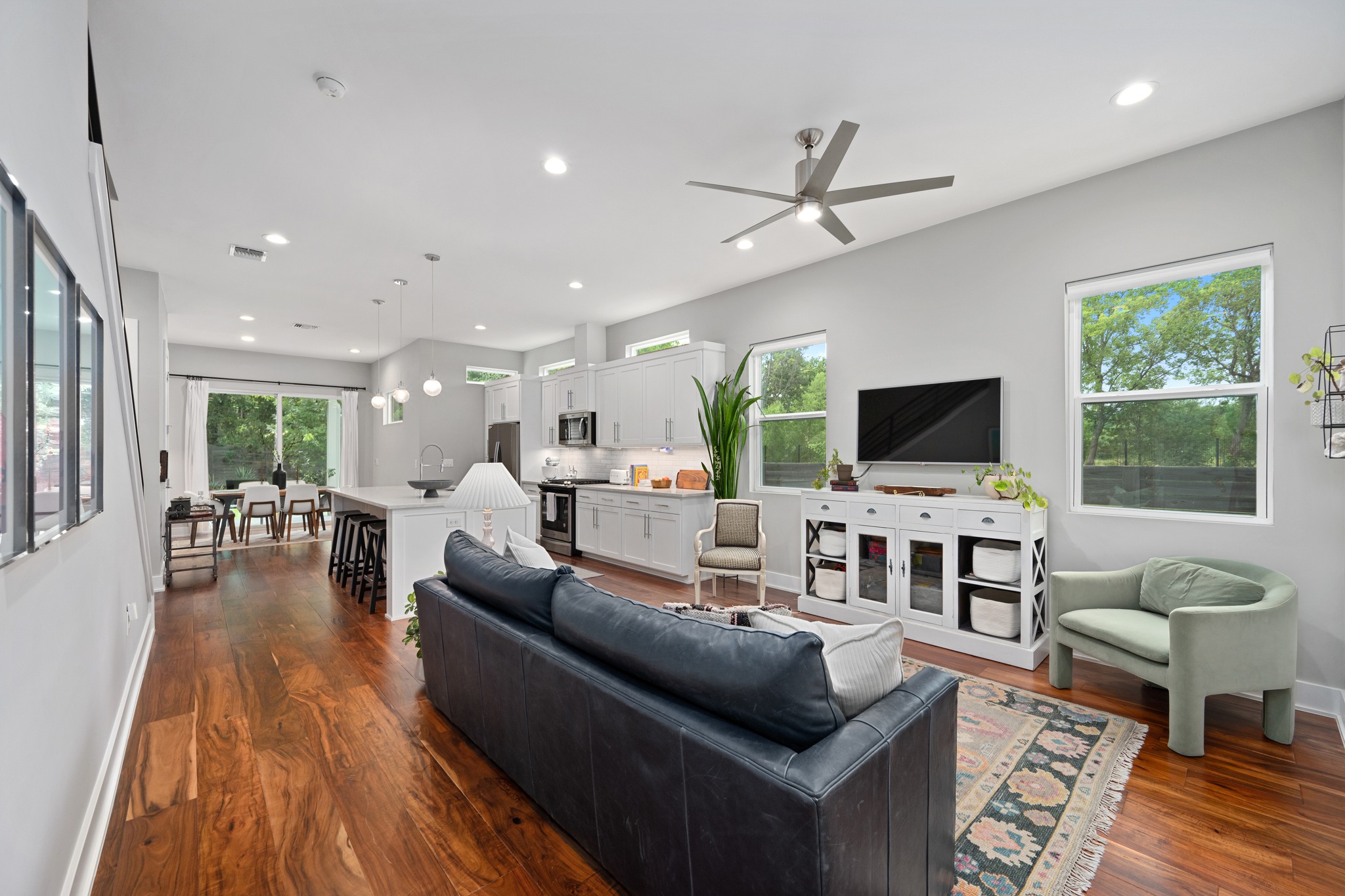 1103 Saucedo Street, Unit 1 Austin, TX 78721 - Photo 6 of 40 A fluid layout seamlessly connects the chef's kitchen to the living and dining areas, all bathed in natural light.