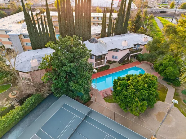 an aerial view of a house with garden space and street view