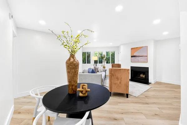 a living room with furniture a chandelier and a fireplace
