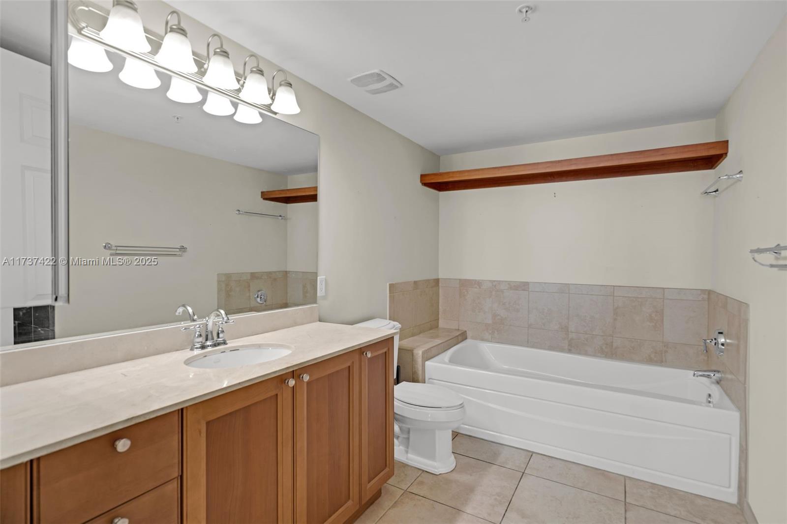 55 Merrick Way, Unit 624 Coral Gables, FL 33134 - Photo 16 of 41 a bathroom with a sink a toilet and shower