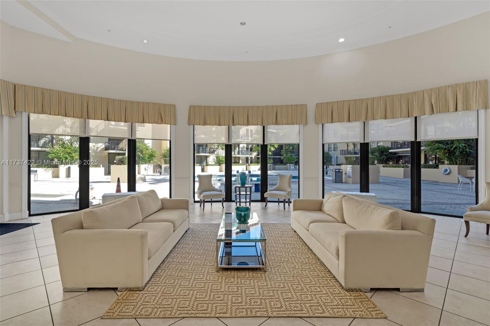 55 Merrick Way, Unit 624 Coral Gables, FL 33134 - Photo 23 of 41 a living room with furniture and a large window