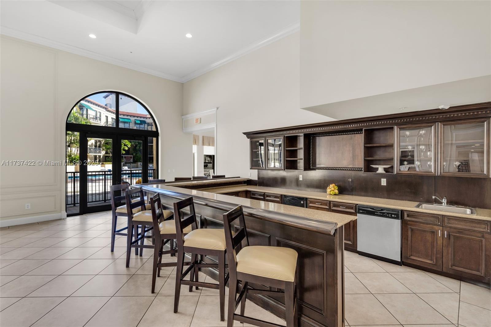 55 Merrick Way, Unit 624 Coral Gables, FL 33134 - Photo 25 of 41 a kitchen with stainless steel appliances granite countertop table chairs sink and cabinets