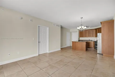 a view of a kitchen with a sink cabinets and refrigerator