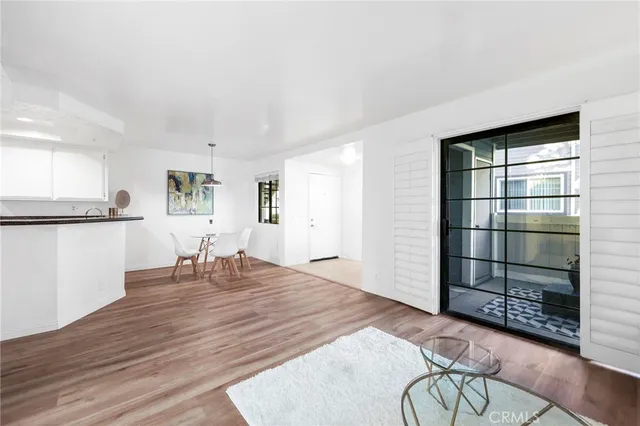 an empty room with furniture and wooden floor