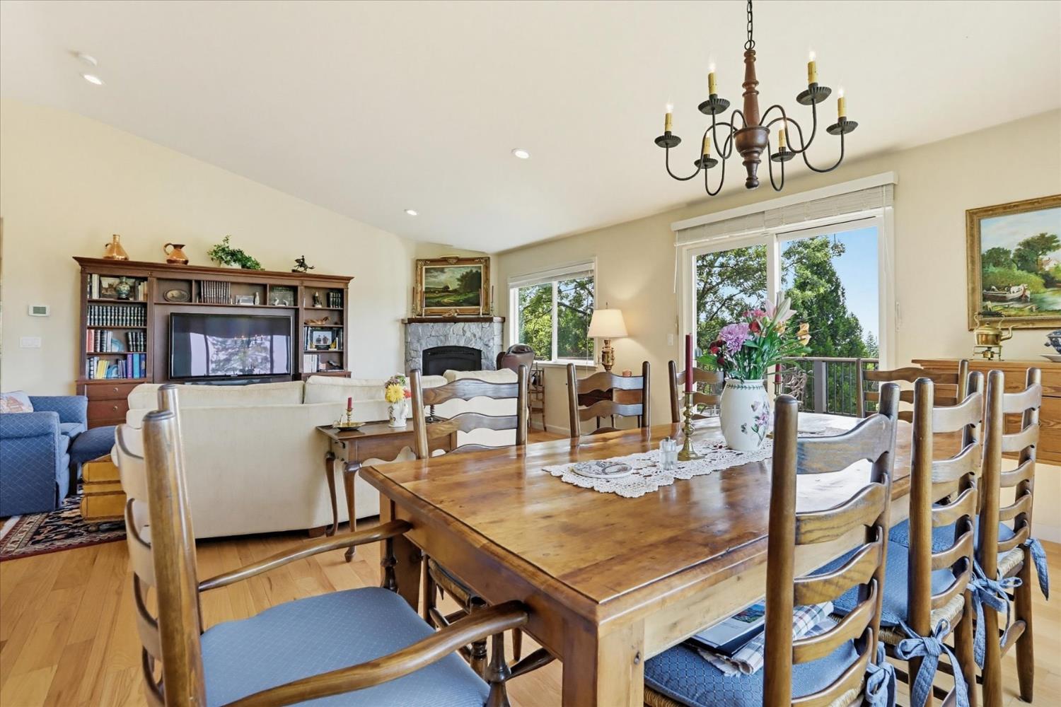970 Morgan Ranch Drive Grass Valley, CA 95945 - Photo 12 of 76 a living room with furniture a chandelier a large window and a dining table