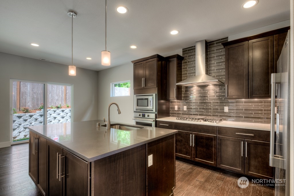 13 178th Place Southwest Bothell, WA 98012 - Photo 3 of 26 a kitchen with stainless steel appliances granite countertop a sink stove and refrigerator
