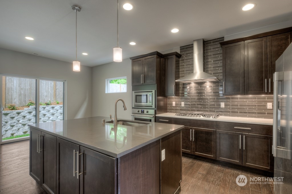 13 178th Place Southwest Bothell, WA 98012 - Photo 4 of 26 a kitchen with stainless steel appliances granite countertop a sink a stove and a refrigerator