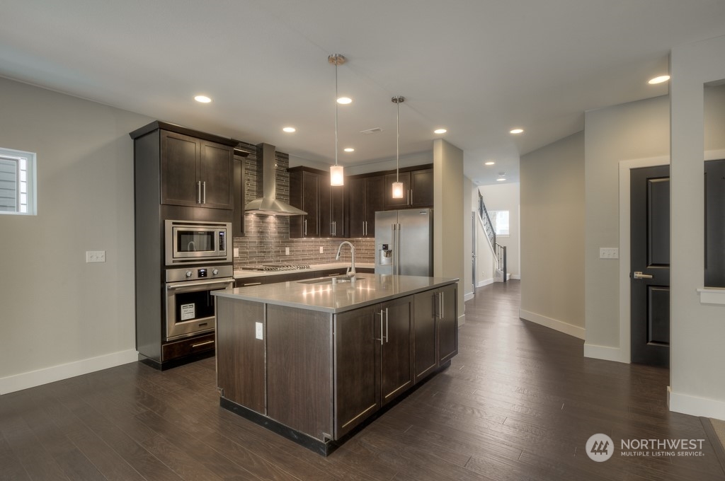 13 178th Place Southwest Bothell, WA 98012 - Photo 5 of 26 a kitchen with stainless steel appliances granite countertop a stove and a refrigerator