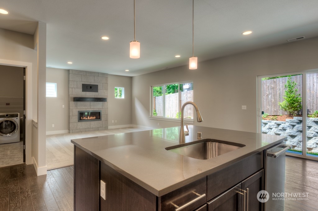 13 178th Place Southwest Bothell, WA 98012 - Photo 6 of 26 a kitchen with kitchen island a sink appliances and a counter space