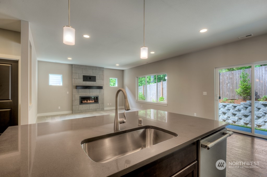 13 178th Place Southwest Bothell, WA 98012 - Photo 9 of 26 a kitchen with kitchen island a sink stainless steel appliances and a counter top space
