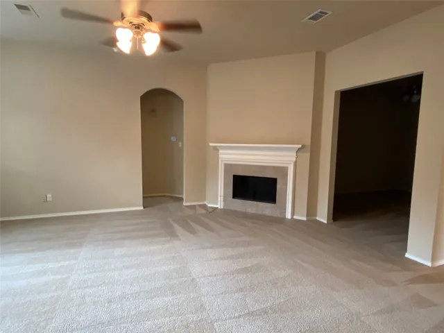 a view of empty room with a fireplace