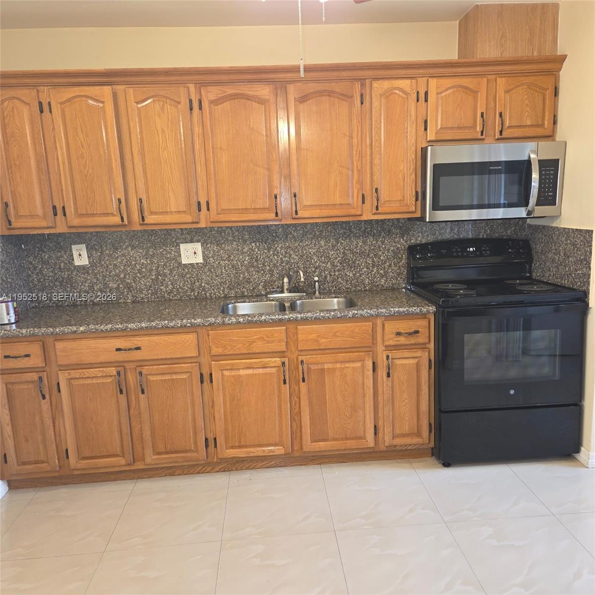 7401 Southwest 21st Street Miami, FL 33155 - Photo 4 of 31 a kitchen with granite countertop a sink and a stove