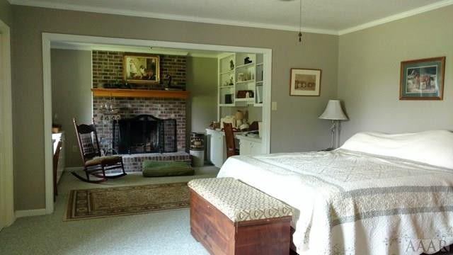 335 Puddin Ridge Road Moyock, NC 27958 - Photo 12 of 29 Master bedroom with built ins and fireplace