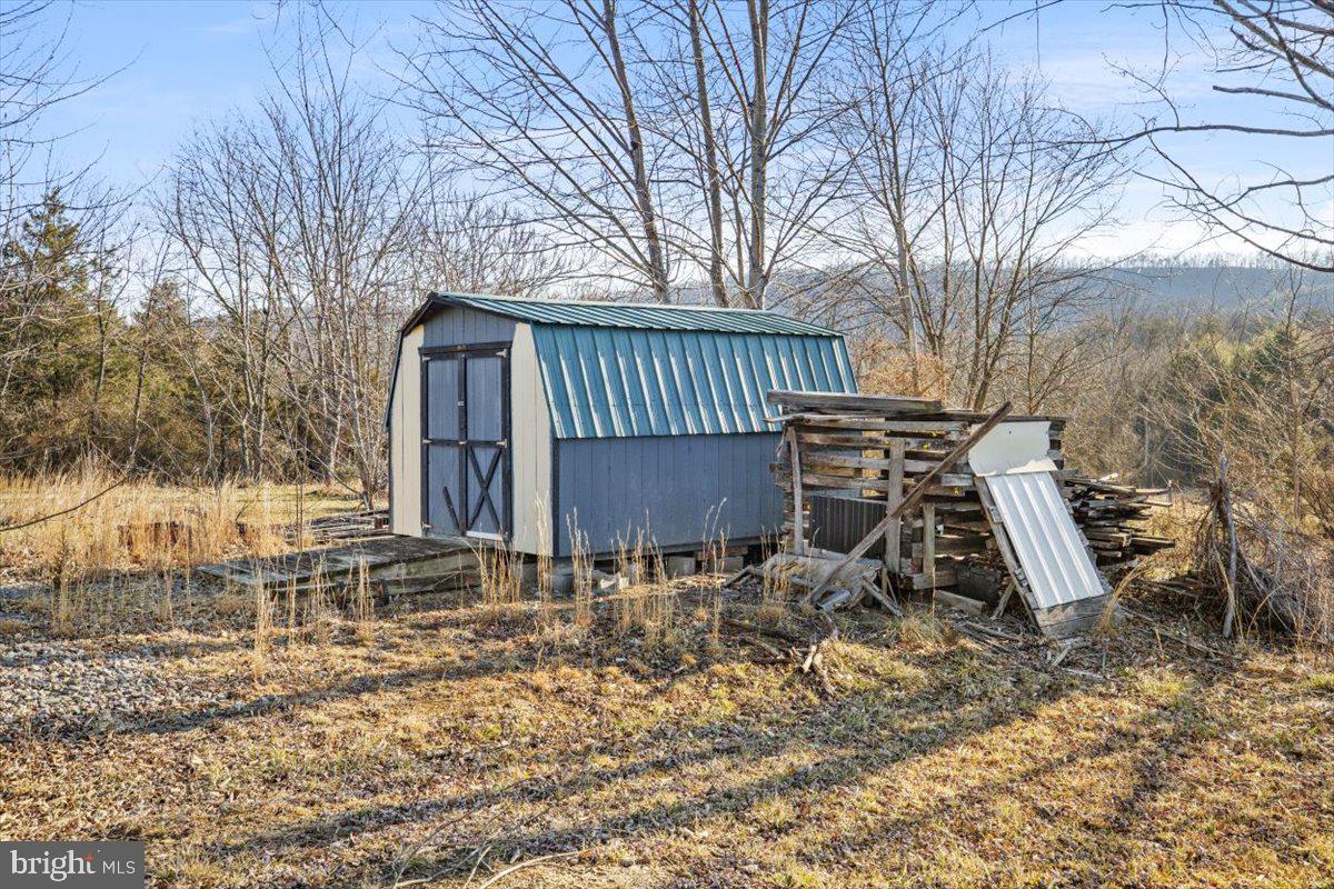 244 Muddy Road Augusta, WV 26704 - Photo 15 of 33 a backyard of a house with table and chairs