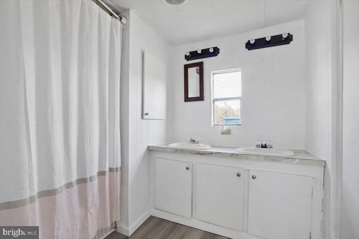 244 Muddy Road Augusta, WV 26704 - Photo 24 of 33 a bathroom with a granite countertop sink and a mirror