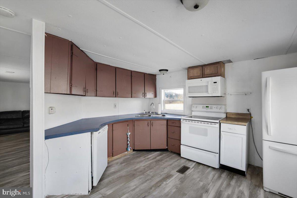 244 Muddy Road Augusta, WV 26704 - Photo 33 of 33 a kitchen with cabinets a sink and white appliances