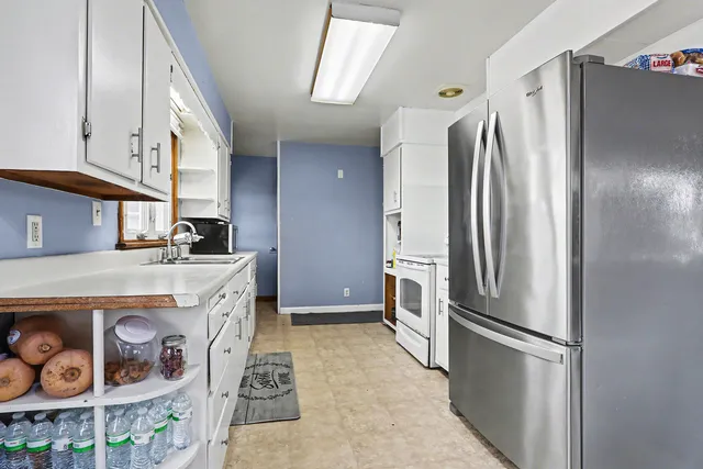 a kitchen with stainless steel appliances a refrigerator and a stove