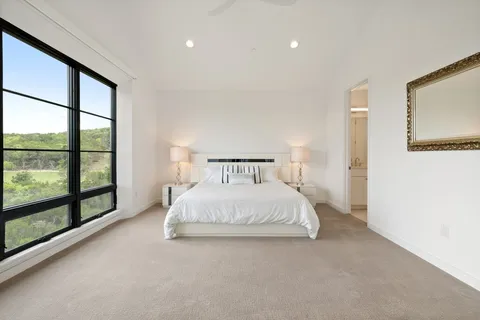 a bedroom with a large bed and a large window