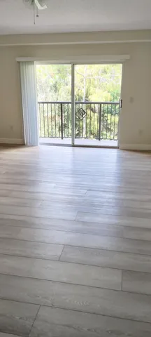 a view of wooden floor and windows in a room