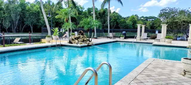 a view of a swimming pool with chairs