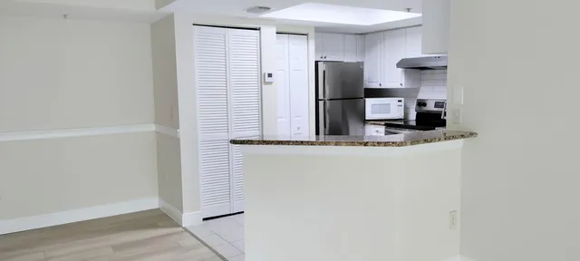 a kitchen with a refrigerator and cabinets