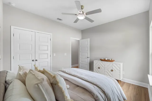 a bedroom with a bed and a chandelier