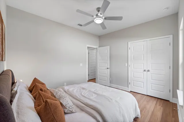 a bedroom with a bed and a chandelier